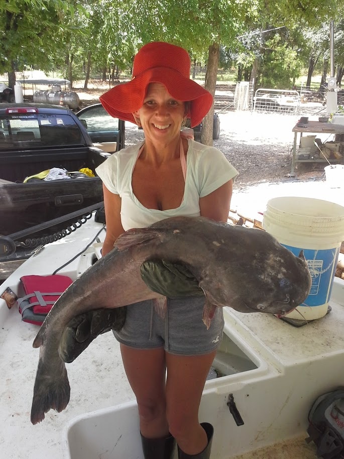 Woman holding a large catfish after a jugline trip on Lake Texoma