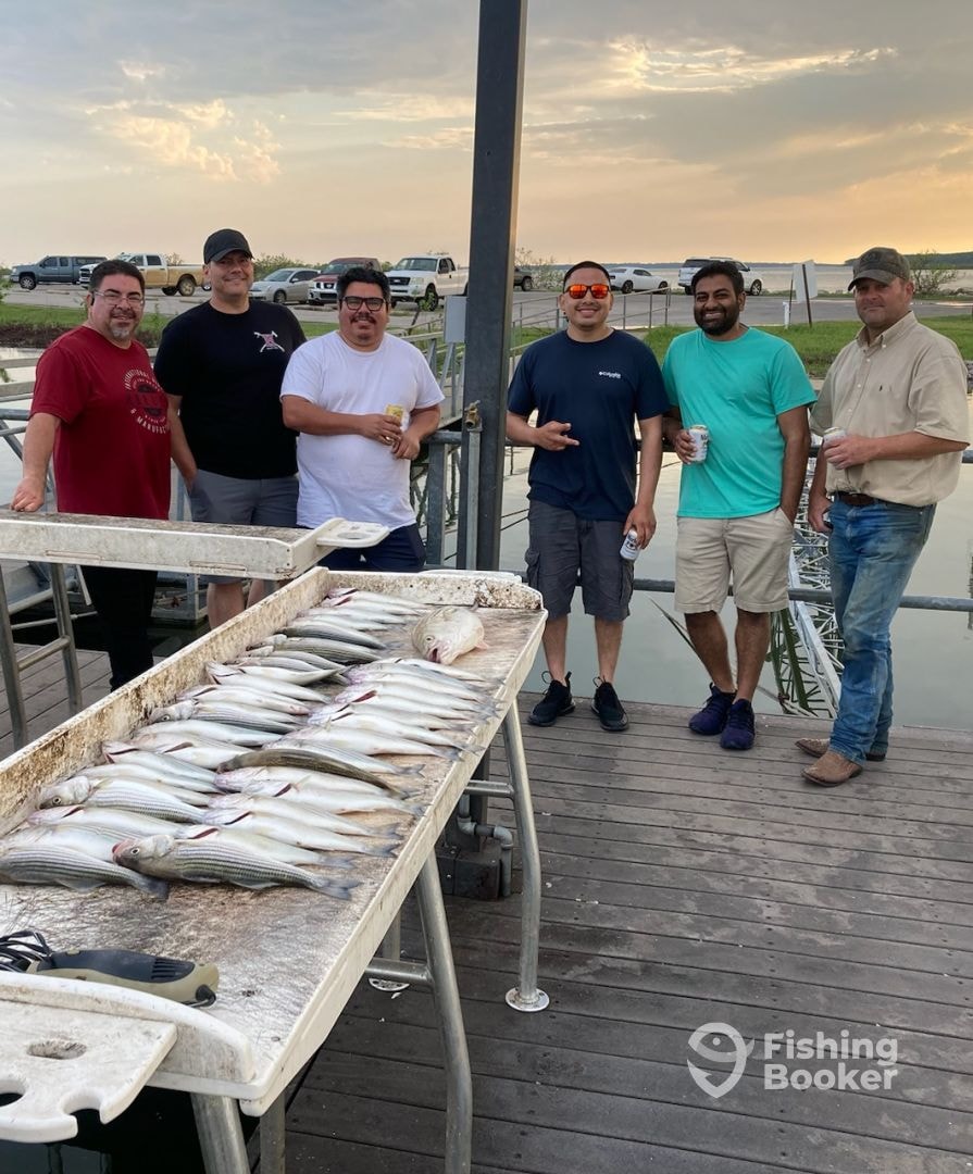Group of six with a big catch at sunset